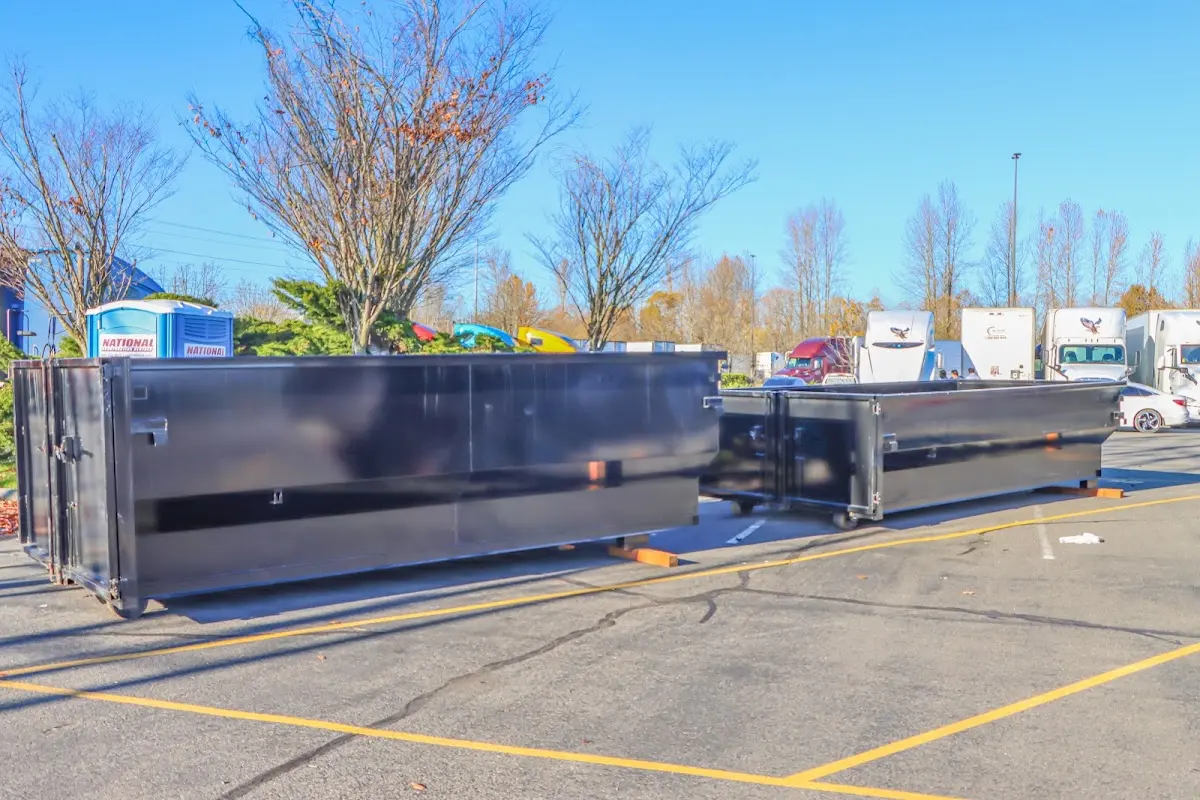 Professional dumpster rental service with roll-off container on residential driveway in Hingham
